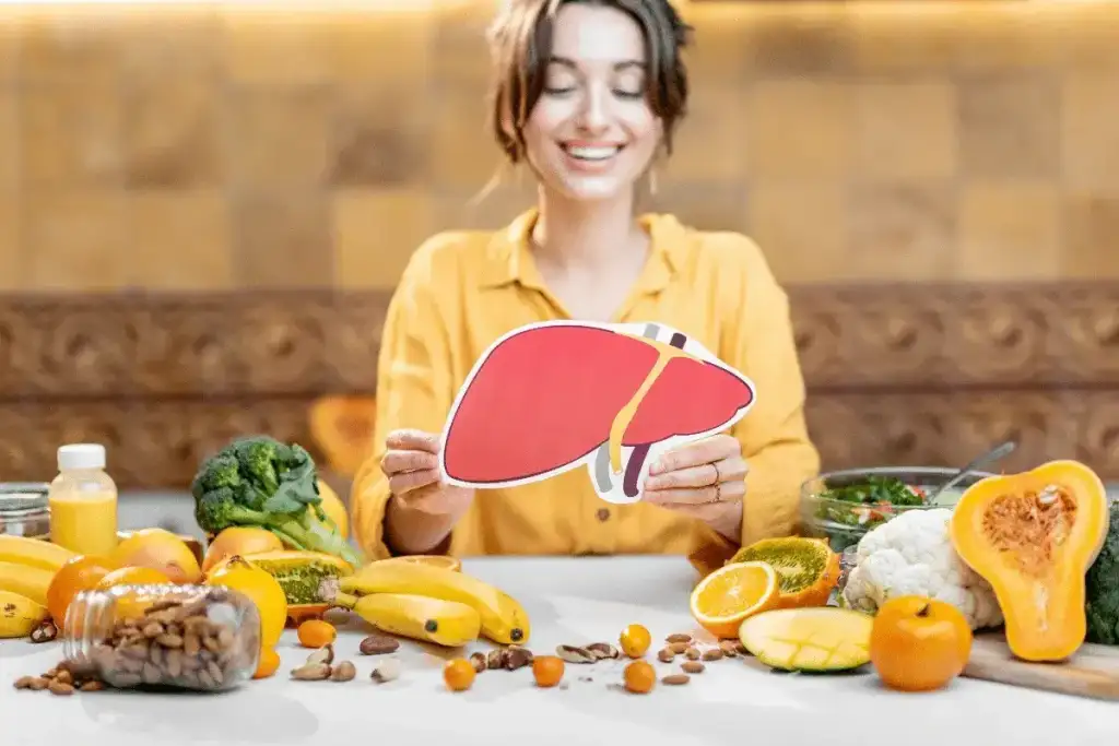 Gordura no fígado tratamento: Mulher com fígado e alimentos saudáveis para esteatose.